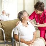 Nurse helping woman in nursing facility - Fire in assisted living